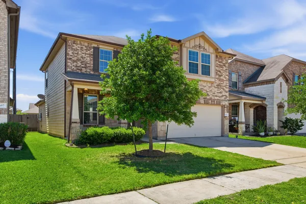 a front view of a house with a yard