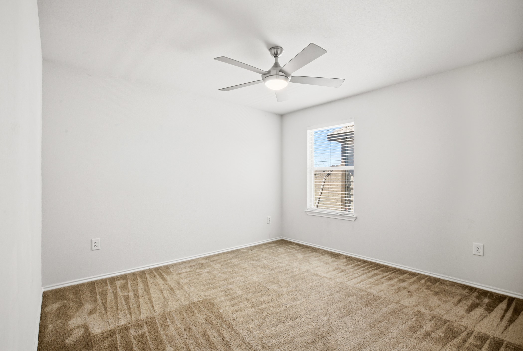 4611 Windmill Run Drive Houston, TX 77069 - Photo 32 of 35 an empty room with a window and ceiling fan
