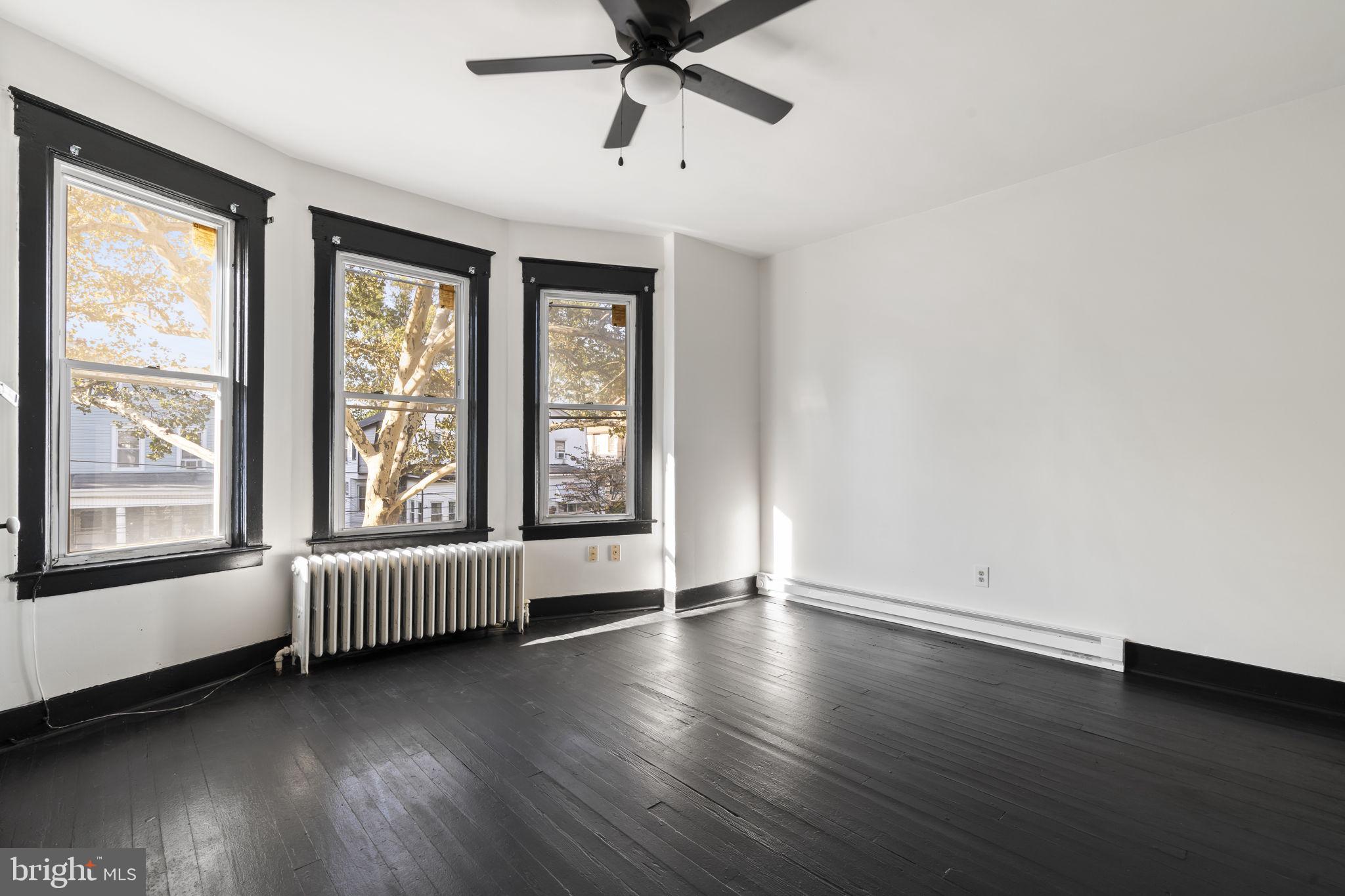724 Ash Avenue, Unit 2 Collingdale, PA 19023 - Photo 12 of 17 wooden floor in an empty room with a window