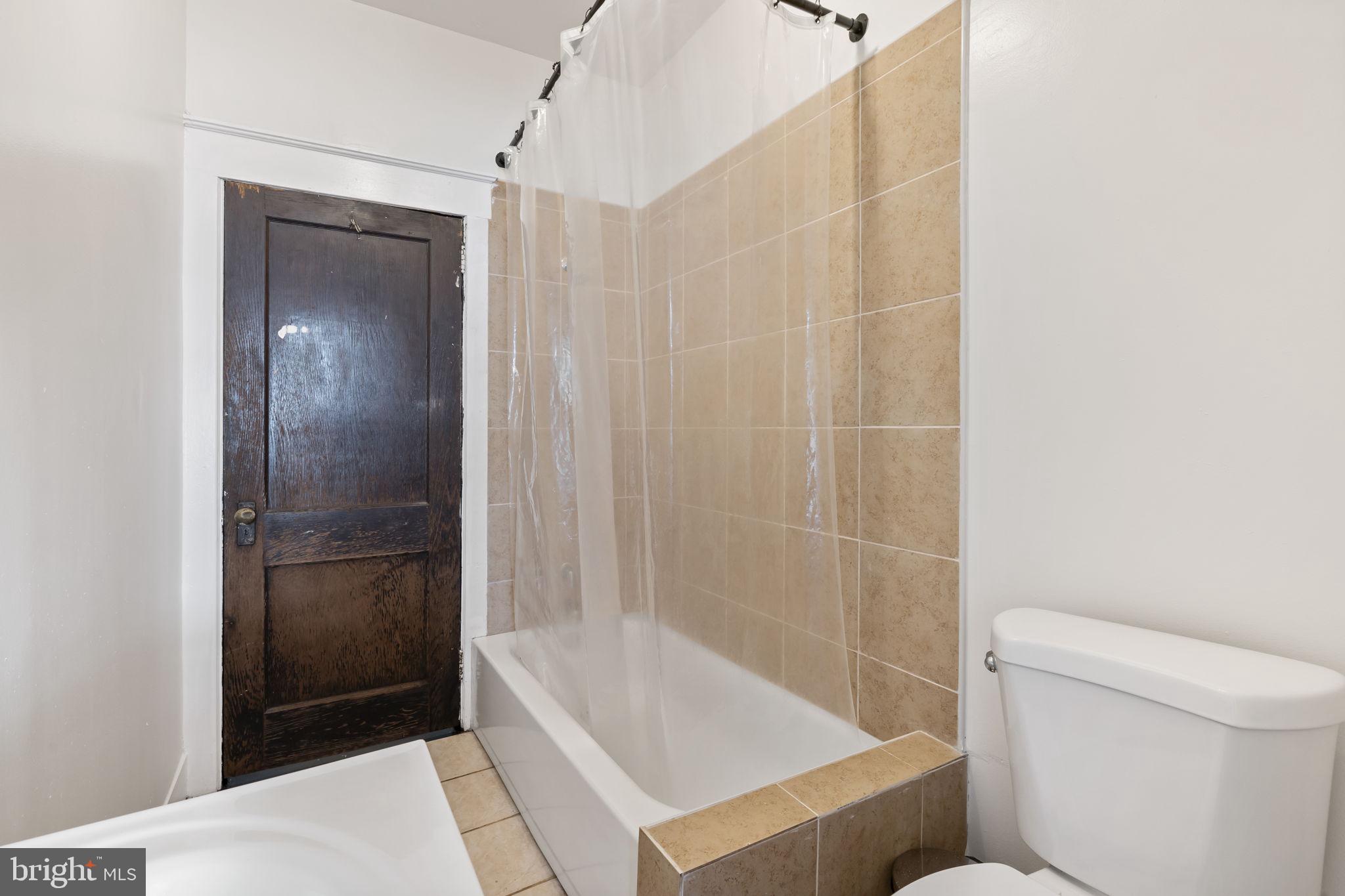 724 Ash Avenue, Unit 2 Collingdale, PA 19023 - Photo 9 of 17 a bathroom with a shower and a toilet