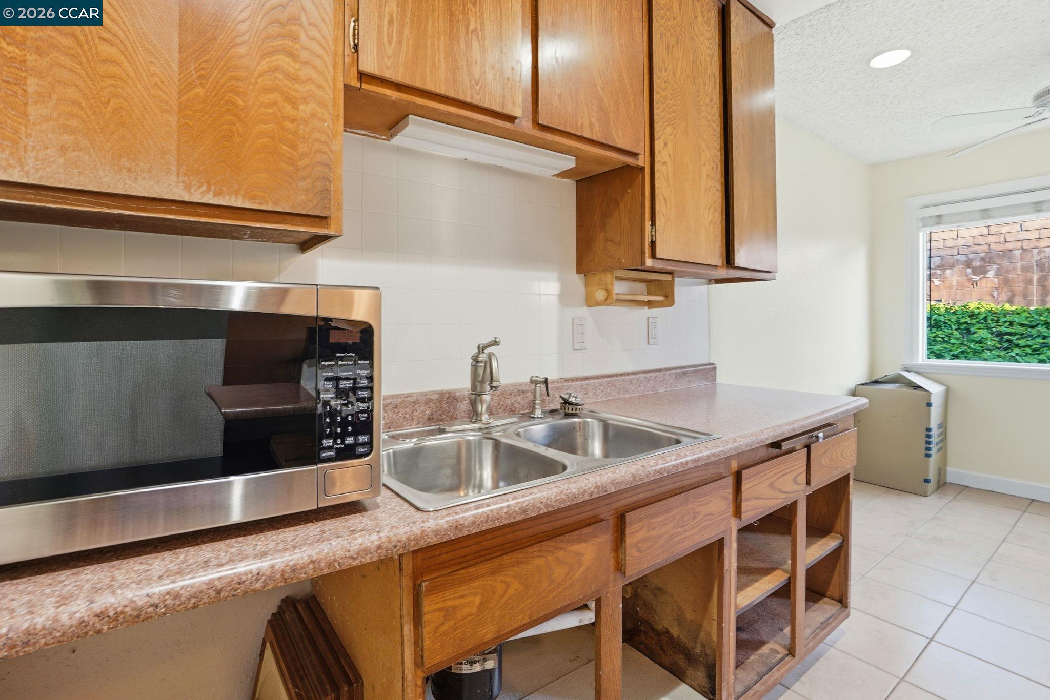 1160 Kenwal Road, Unit D Concord, CA 94521 - Photo 14 of 38 a kitchen with stainless steel appliances granite countertop a sink and a stove