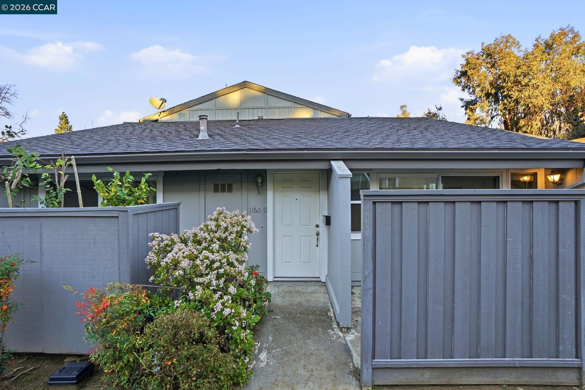 1160 Kenwal Road, Unit D Concord, CA 94521 - Photo 2 of 38 a front view of a house with a garden