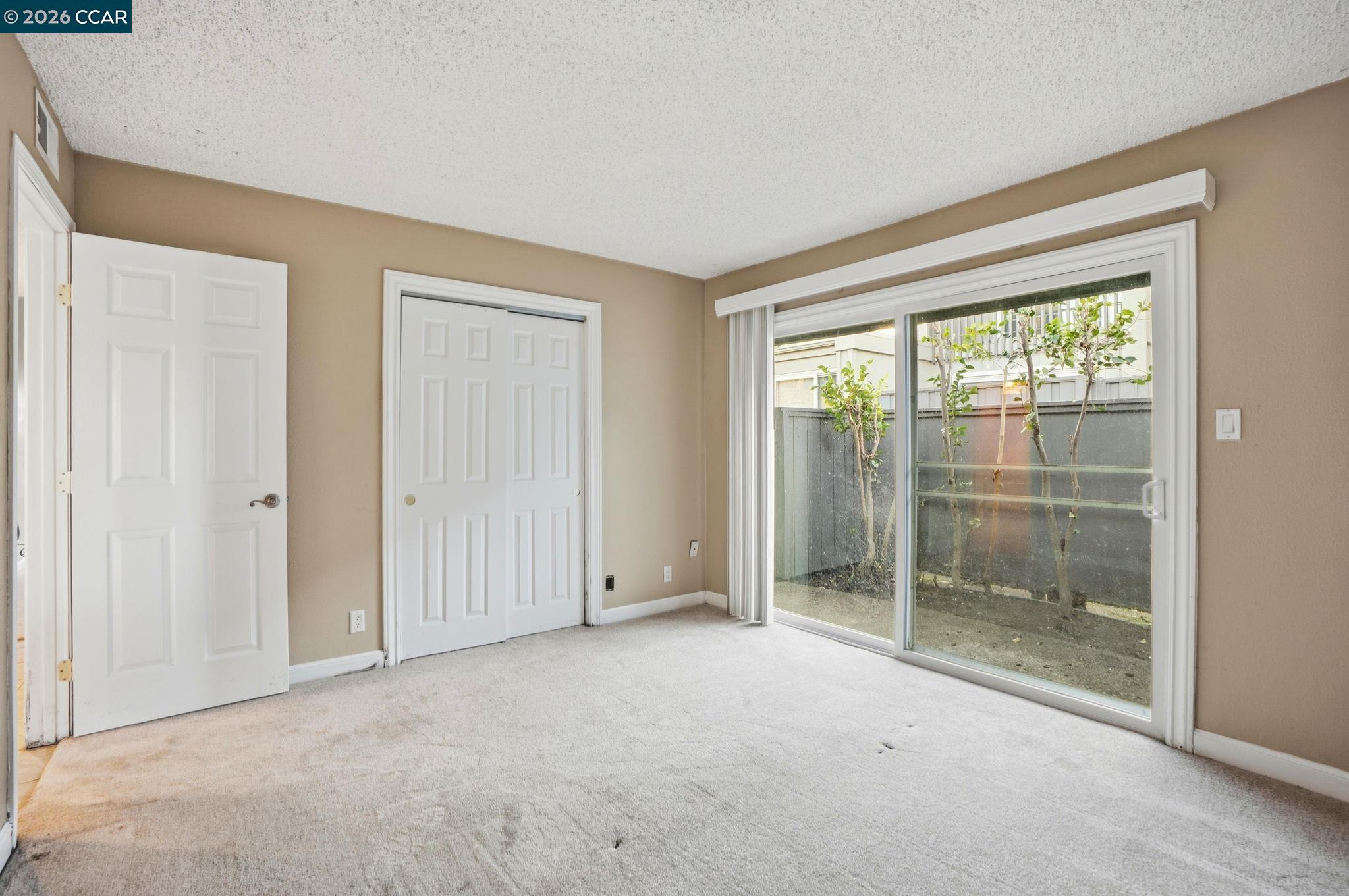 1160 Kenwal Road, Unit D Concord, CA 94521 - Photo 22 of 38 a view of an empty room with glass door