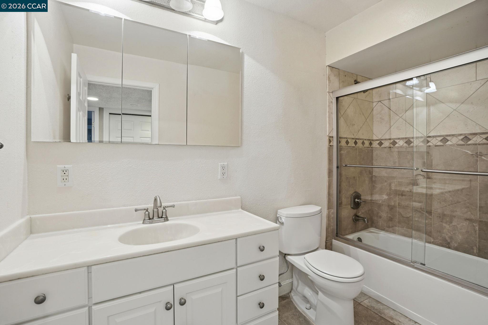 1160 Kenwal Road, Unit D Concord, CA 94521 - Photo 24 of 38 a bathroom with a sink toilet a mirror and shower