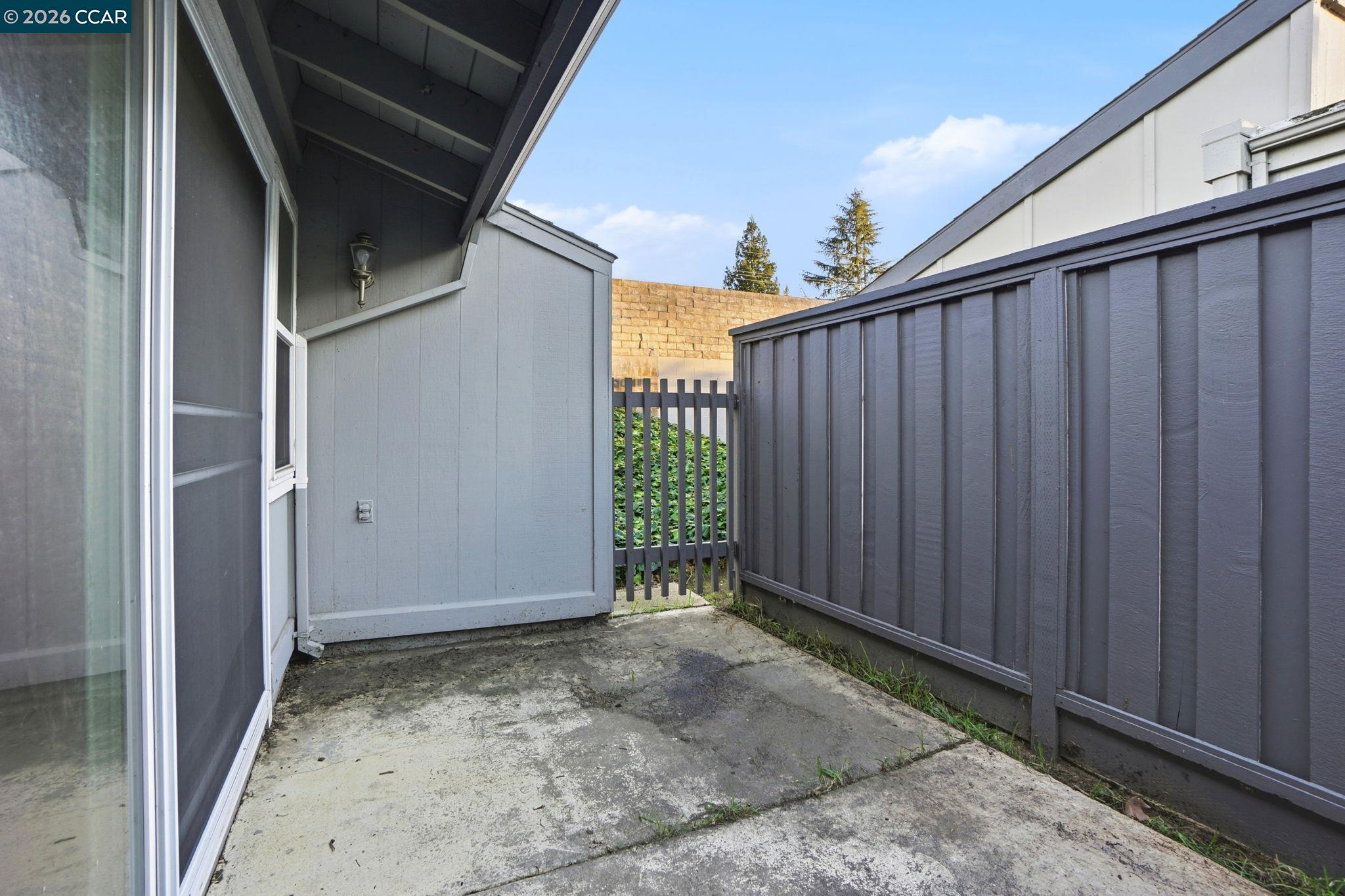 1160 Kenwal Road, Unit D Concord, CA 94521 - Photo 34 of 38 a view of a back yard with wooden fence