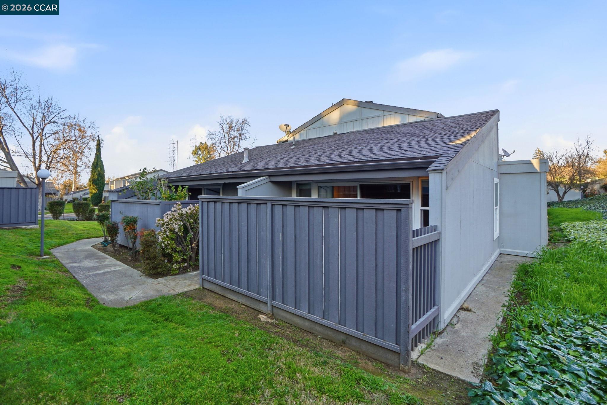 1160 Kenwal Road, Unit D Concord, CA 94521 - Photo 38 of 38 a front view of a house with garden