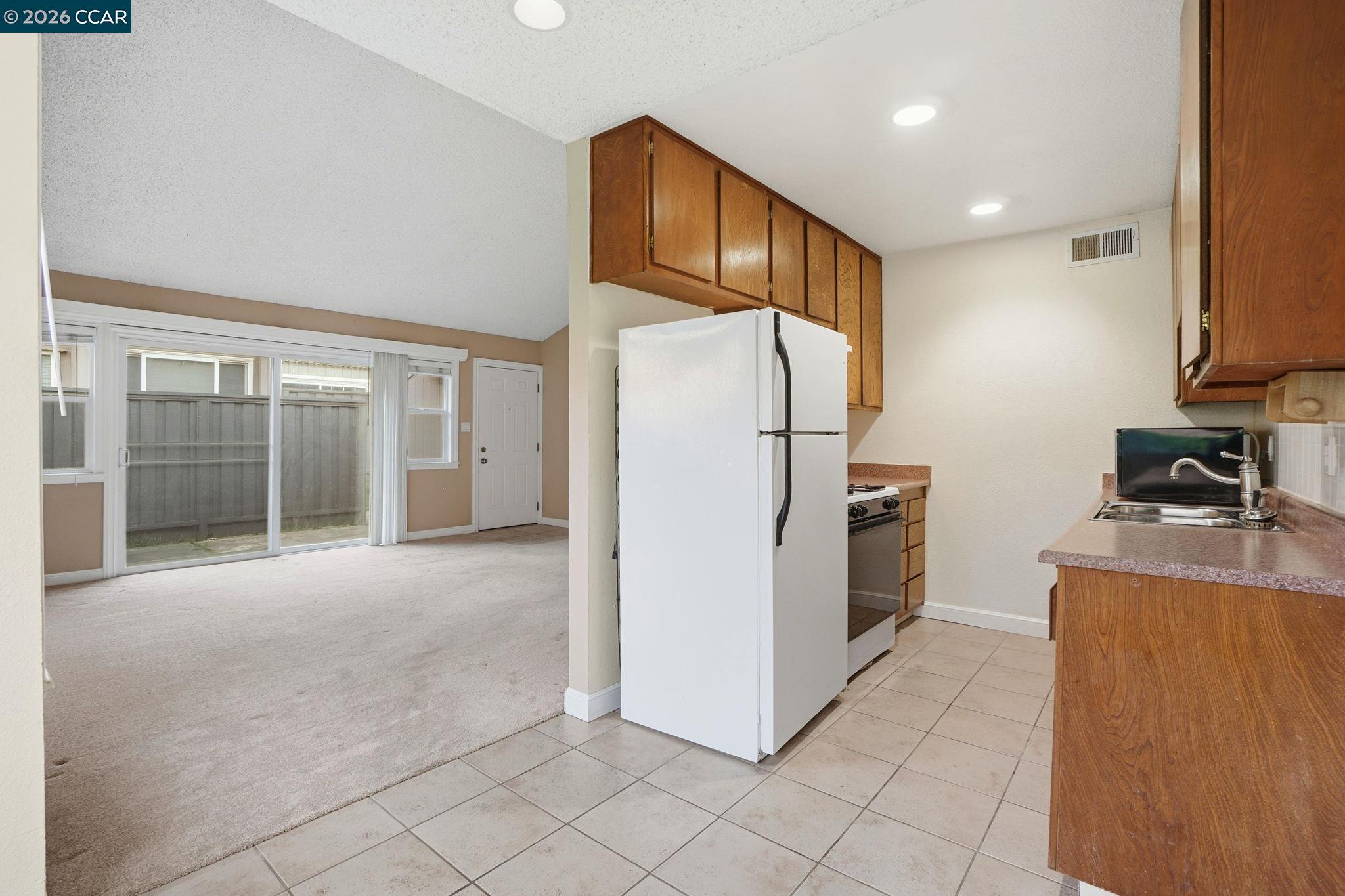 1160 Kenwal Road, Unit D Concord, CA 94521 - Photo 10 of 38 a view of kitchen with refrigerator and cabinets