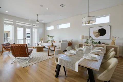 a living room with furniture kitchen view and a table