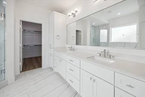 a view of walk in closet with empty racks