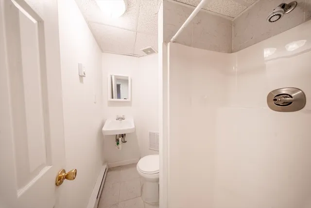 a bathroom with a toilet and a shower