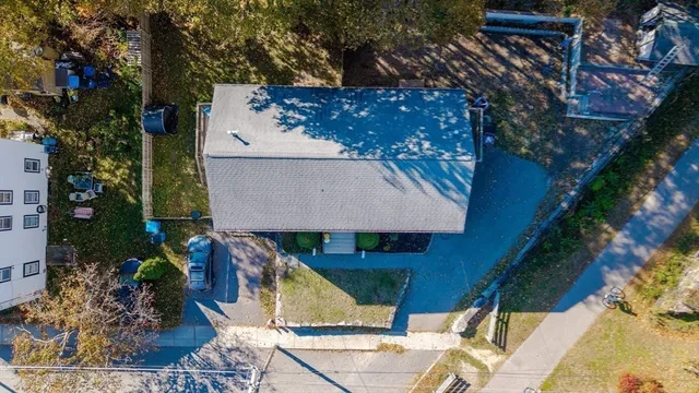 an aerial view of a house with a yard