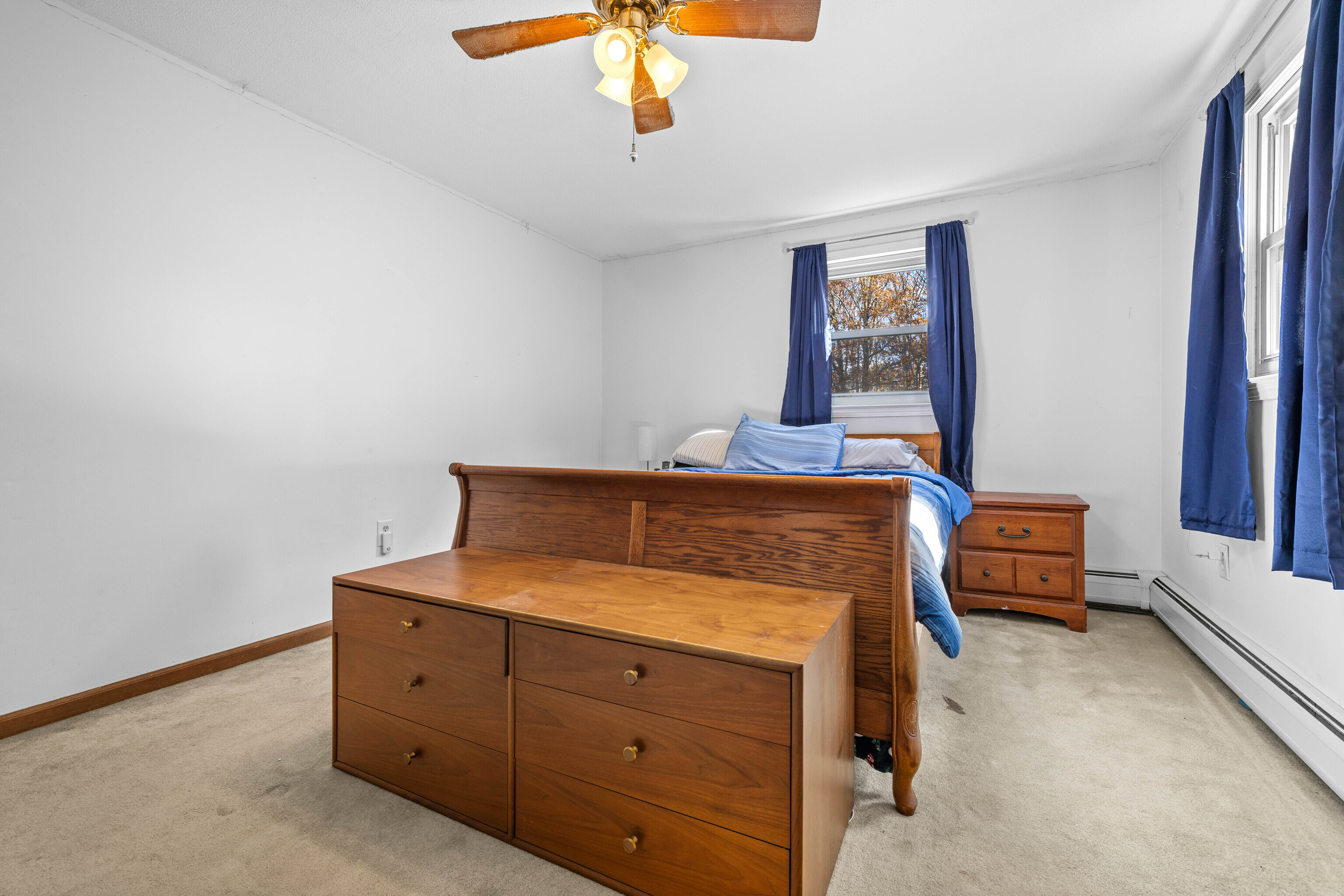 63 Burr Road Haddam, CT 06441 - Photo 27 of 38 a bedroom with a bed and a chandelier