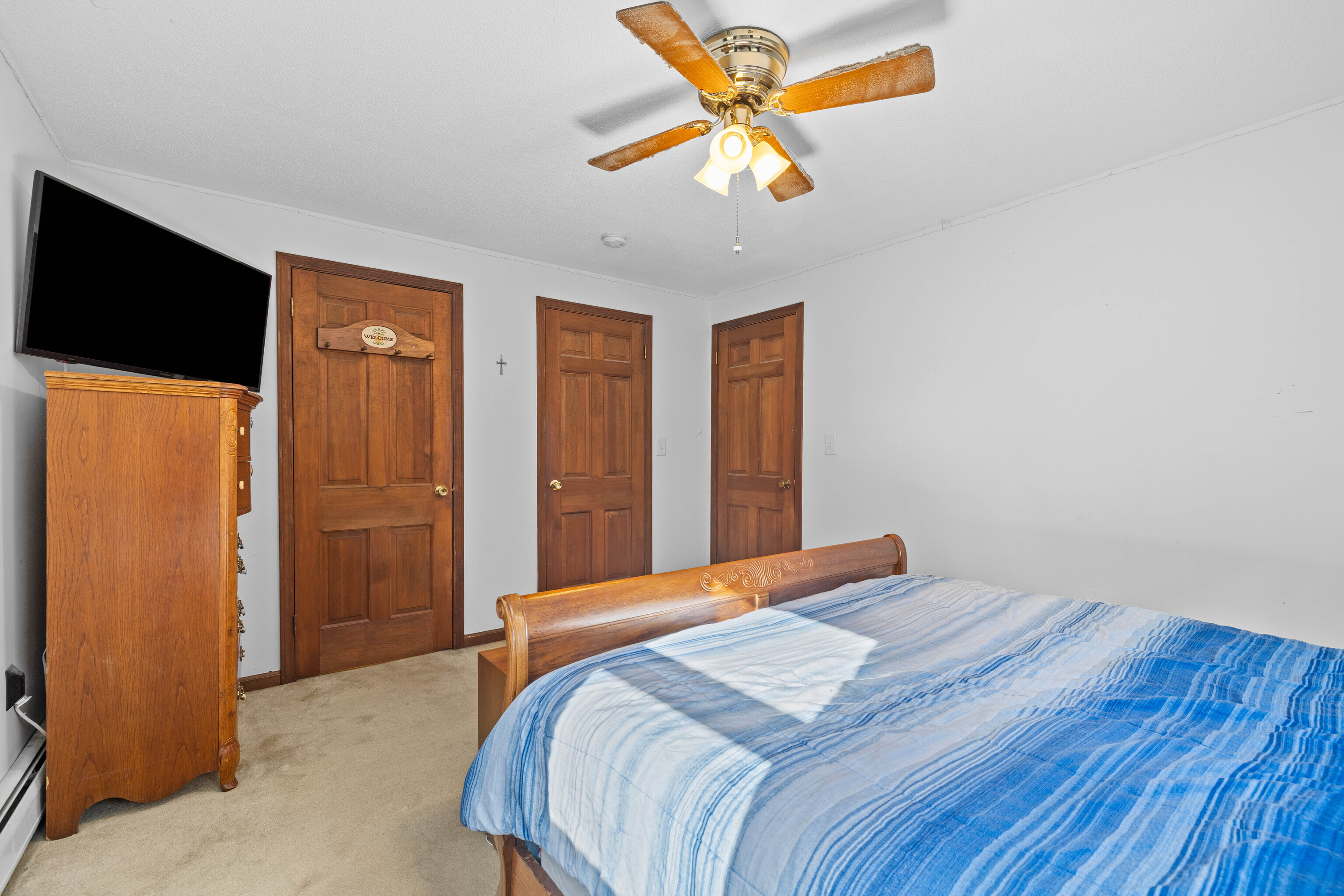 63 Burr Road Haddam, CT 06441 - Photo 28 of 38 a bedroom with a bed and a chandelier