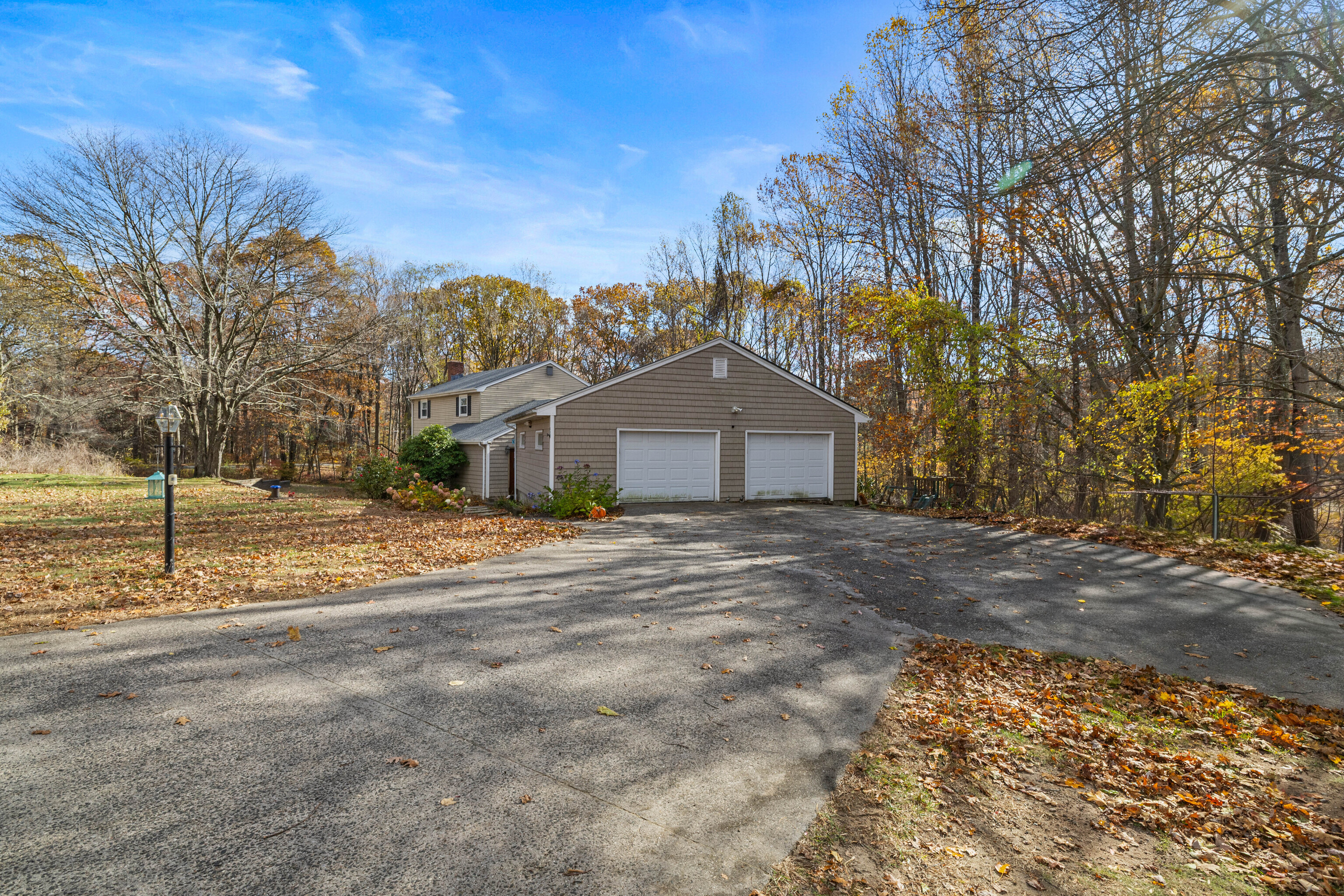 63 Burr Road Haddam, CT 06441 - Photo 4 of 38 a front view of a house with a yard and garage