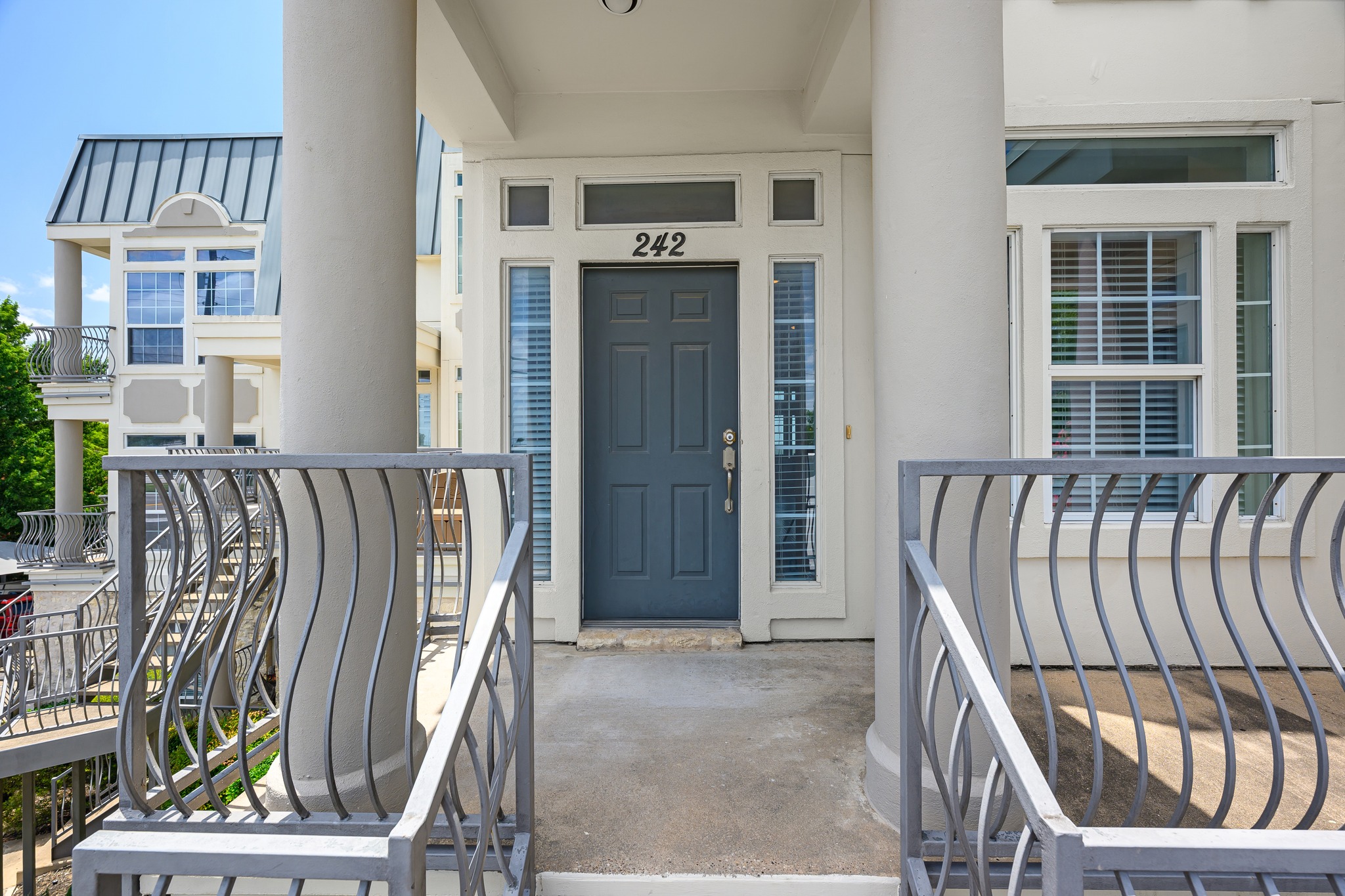 2918 Ranch Road 620 North, Unit S242 Austin, TX 78734 - Photo 3 of 35 A welcoming front entrance features classic columns and decorative railings leading to the main door.
