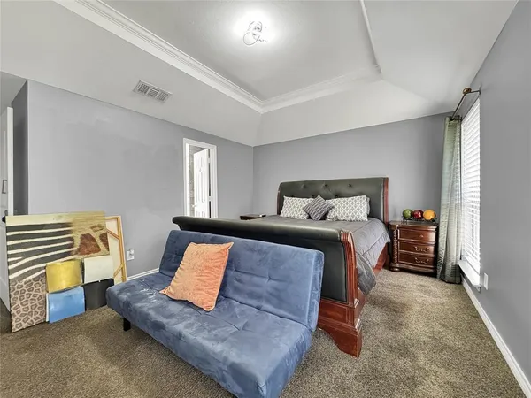 a bedroom with a bed and a couch