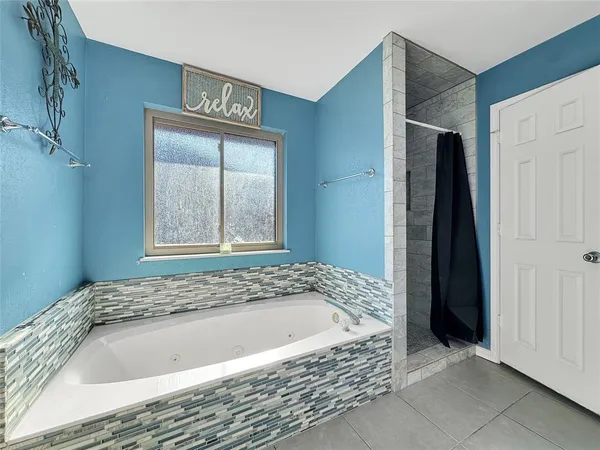 a bathroom with a bathtub and a shower