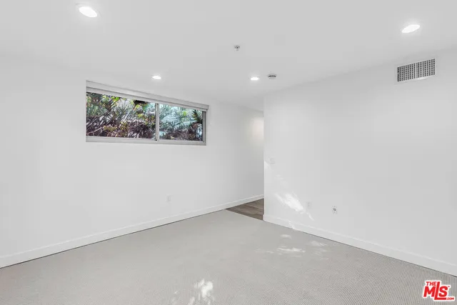 an empty room with wall painting and wooden floor