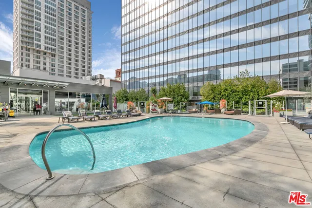 a view of a swimming pool with outdoor seating