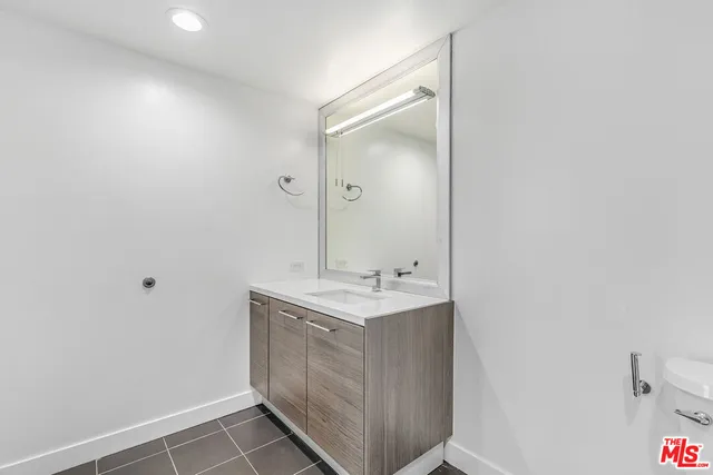 a bathroom with a sink toilet and mirror
