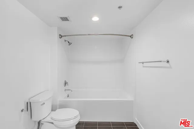 a bathroom with a bathtub and a toilet