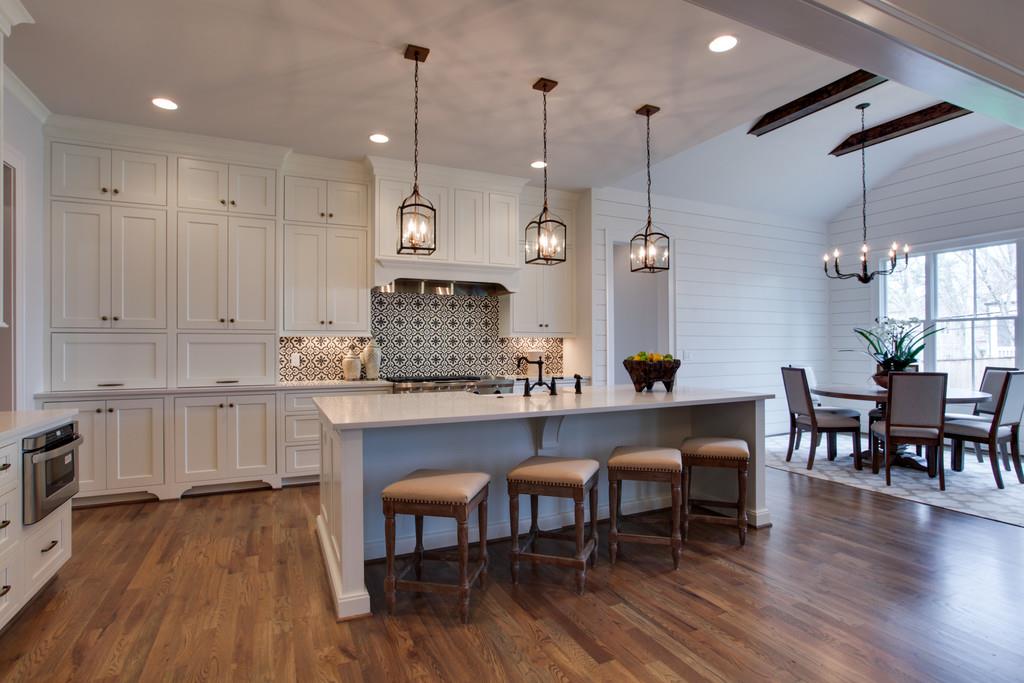 112 Alton Road Nashville, TN 37205 - Photo 11 of 30 a kitchen with stainless steel appliances granite countertop a table chairs stove a refrigerator a sink dishwasher and white cabinets with wooden floor