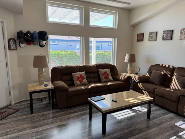 a living room with furniture and a wooden floor