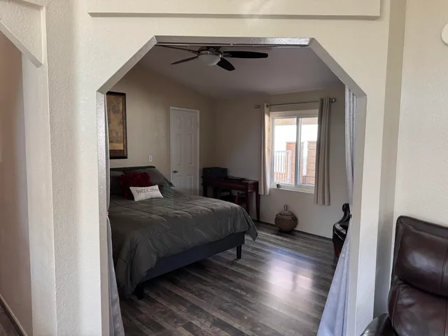 a bedroom with a bed and wooden floor