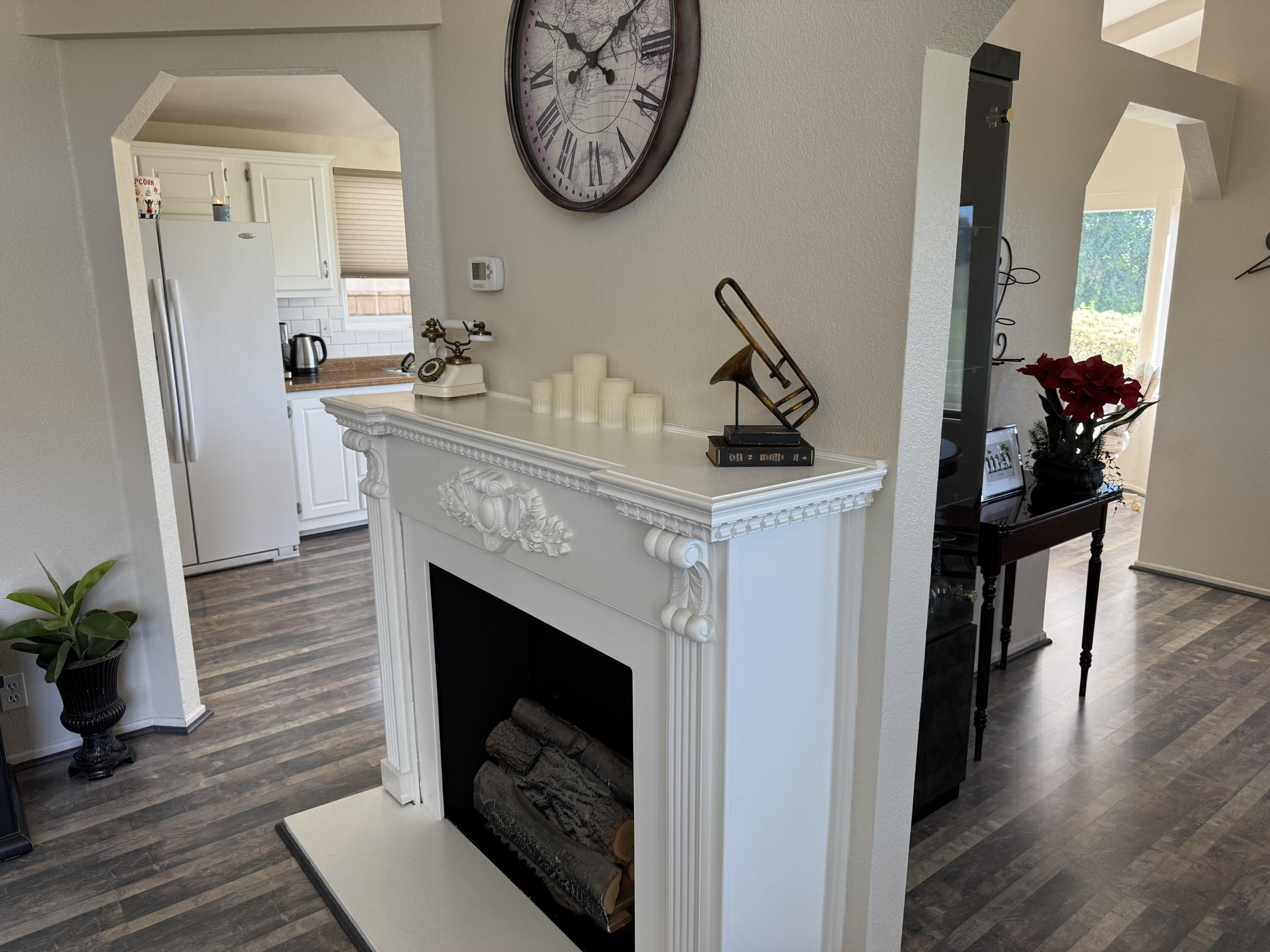 35280 South Border Thousand Palms, CA 92276 - Photo 19 of 50 a living room with furniture a fireplace and a potted plant