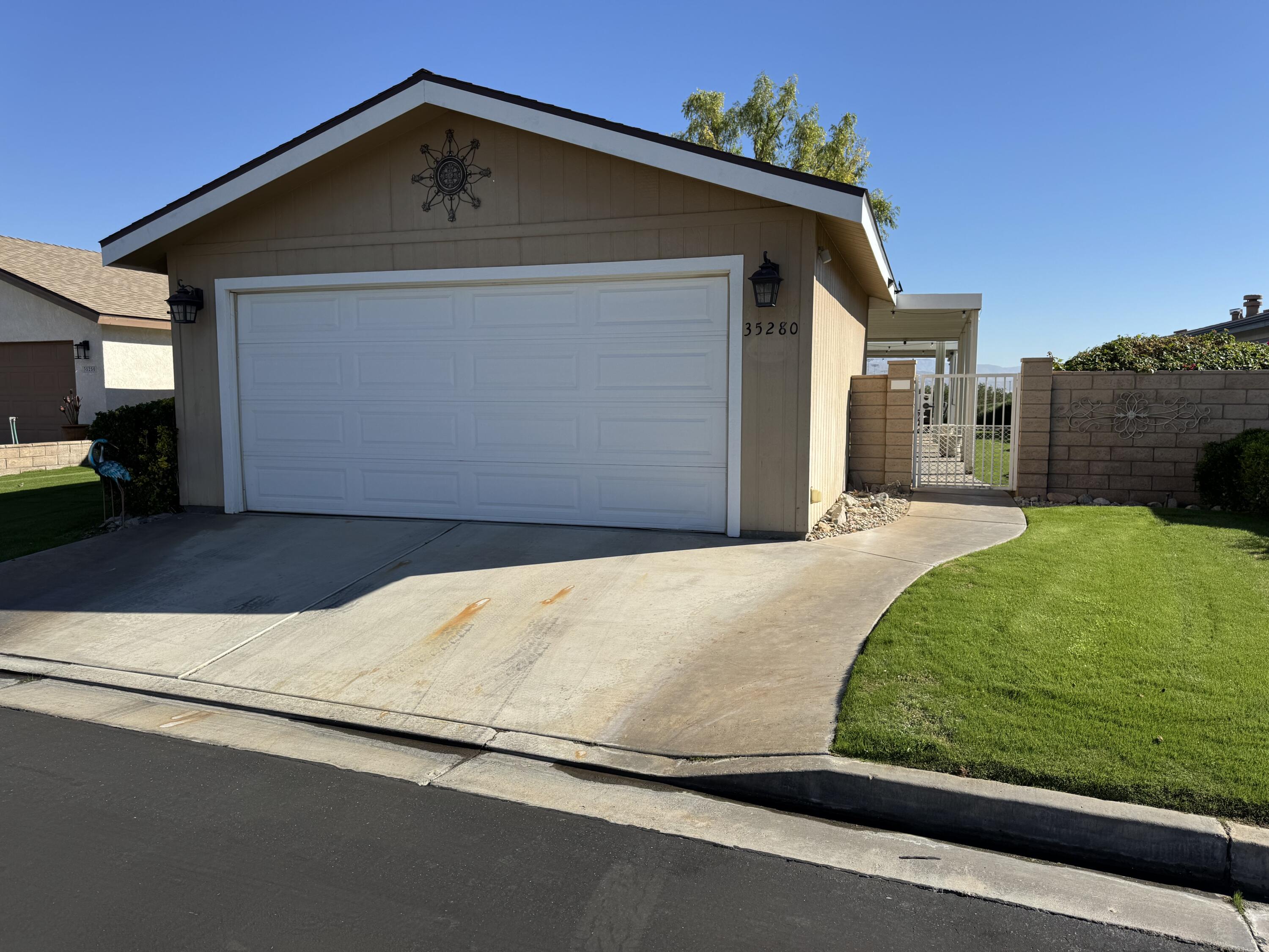 35280 South Border Thousand Palms, CA 92276 - Photo 2 of 50 a front view of a house with a yard