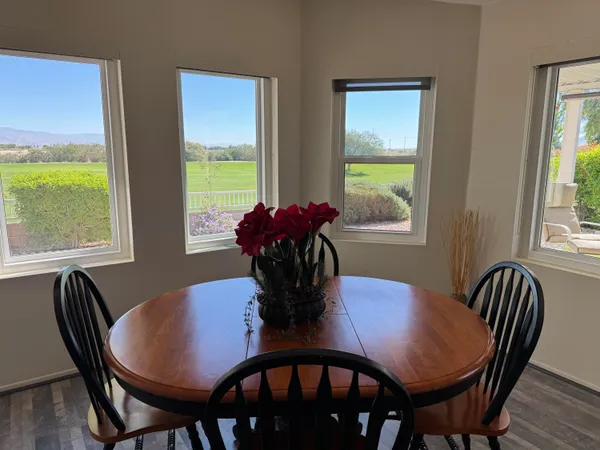 a kitchen with a table chairs refrigerator and cabinets
