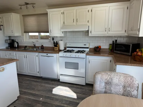 a kitchen with a sink stove and refrigerator