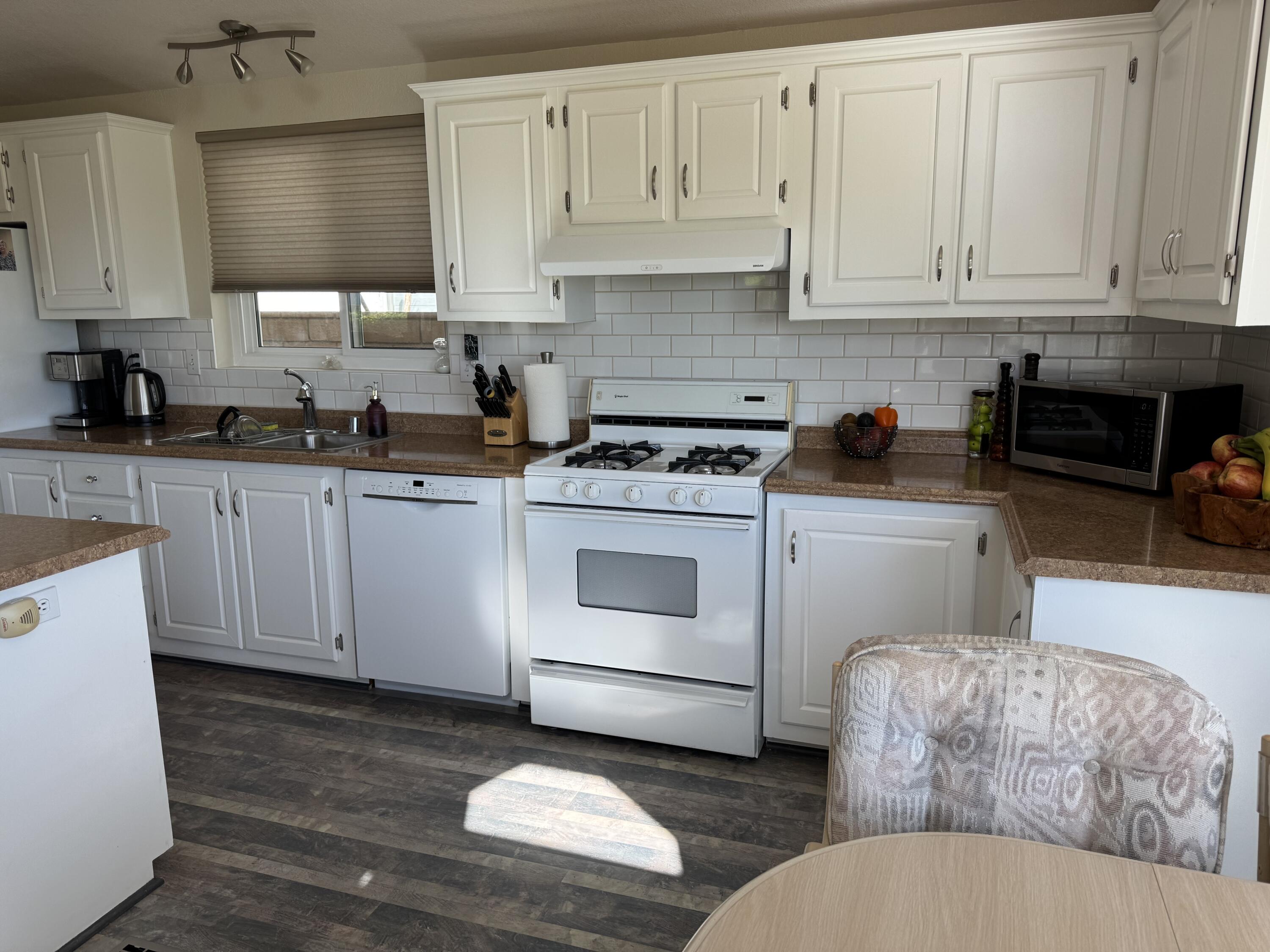 35280 South Border Thousand Palms, CA 92276 - Photo 25 of 50 a kitchen with cabinets appliances a sink and a counter top space