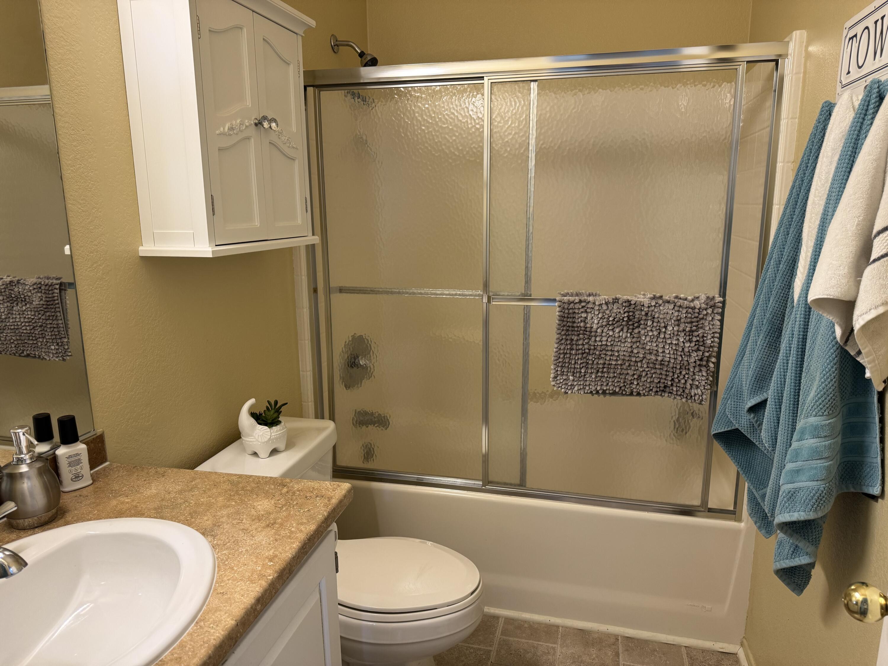 35280 South Border Thousand Palms, CA 92276 - Photo 29 of 50 a bathroom with a granite countertop sink toilet and shower