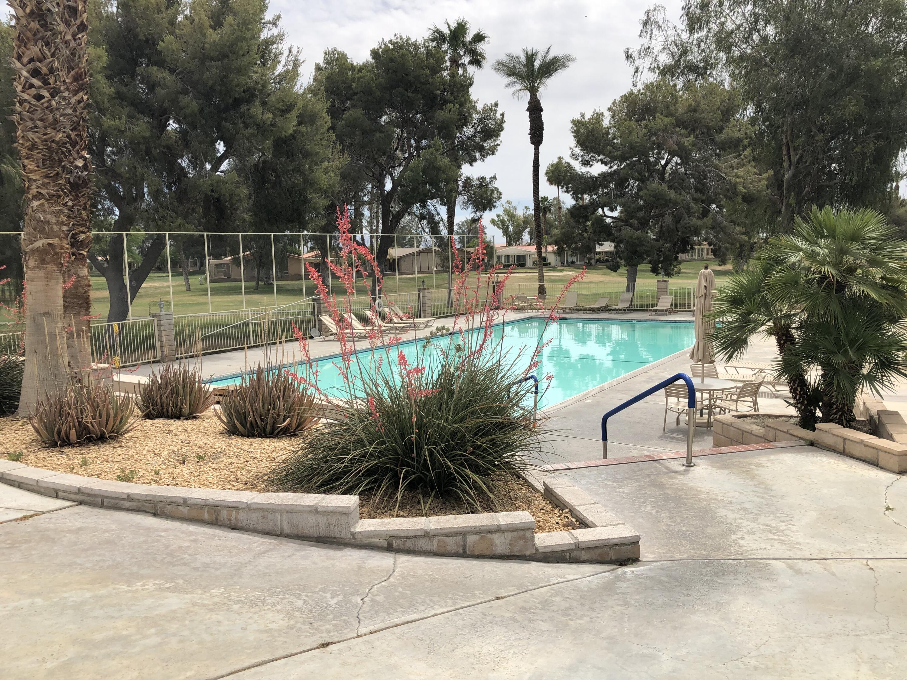 35280 South Border Thousand Palms, CA 92276 - Photo 49 of 50 a view of a swimming pool with a lounge chair and trees