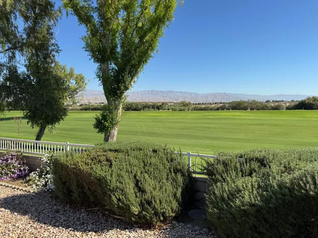 a view of a garden with an ocean and trees