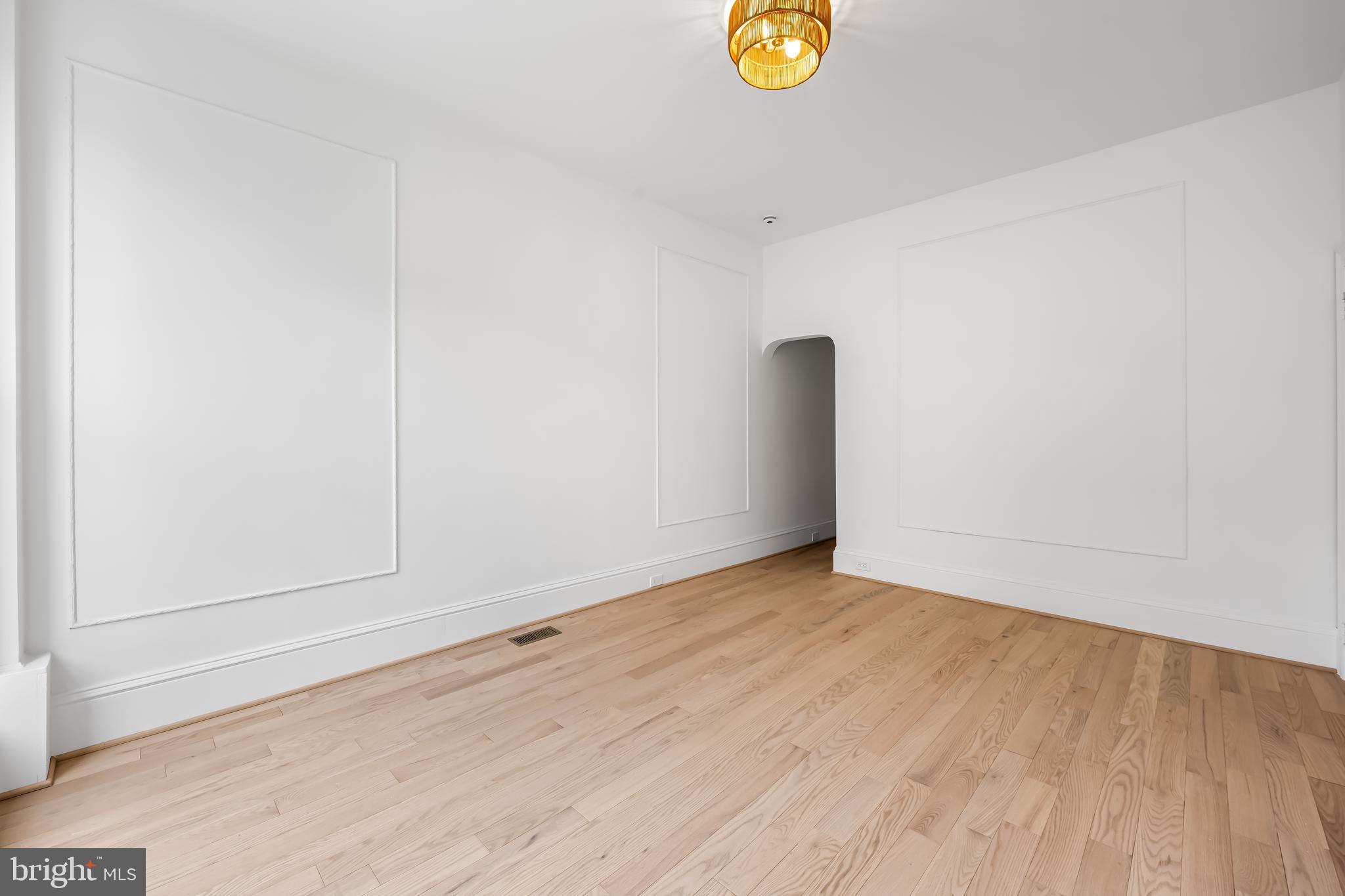 1202 Bolton Street, Unit 1 Baltimore, MD 21217 - Photo 7 of 22 an empty room with wooden floor