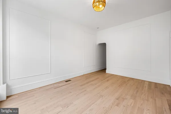 an empty room with wooden floor