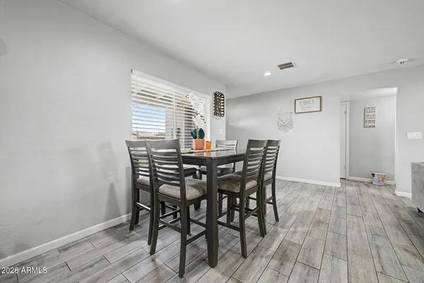 a view of a dining room with furniture and wooden floor