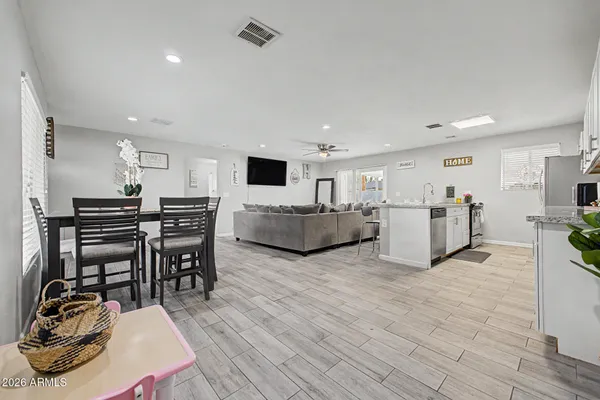 a living room with furniture and a wooden floor