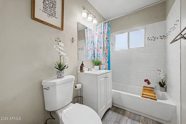a bathroom with a sink a toilet and shower curtain