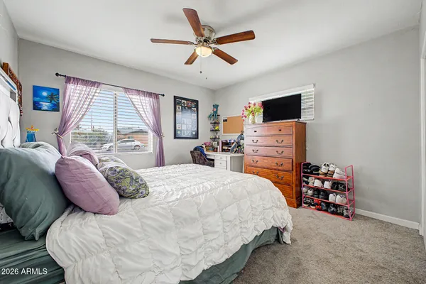 a bedroom with a bed and a tv