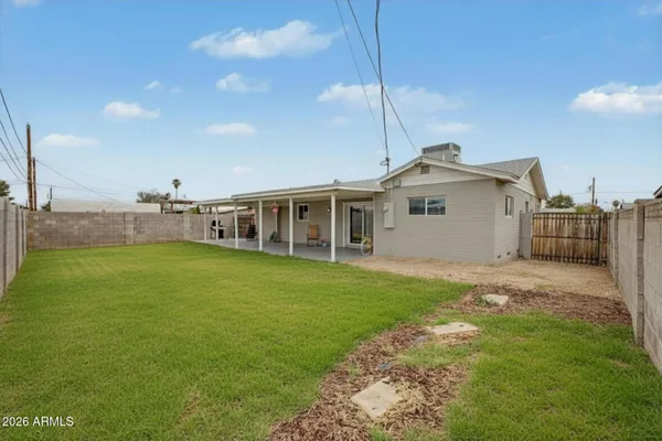 a view of a house with a backyard and a garden