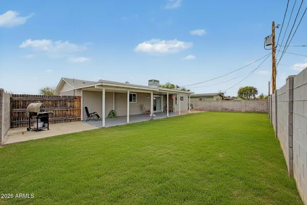 a view of a house with a backyard porch and sitting area