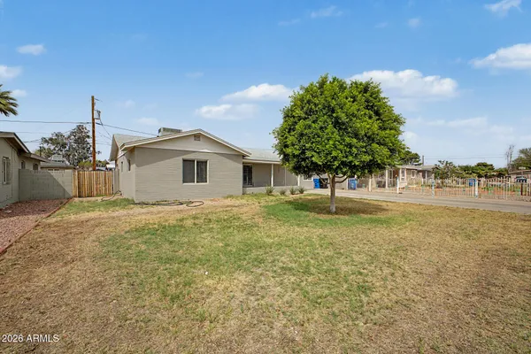 a view of a house with a yard and tree s