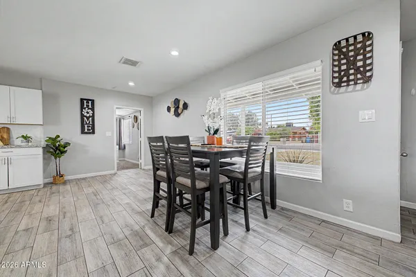 a view of a dining room with furniture and wooden floor
