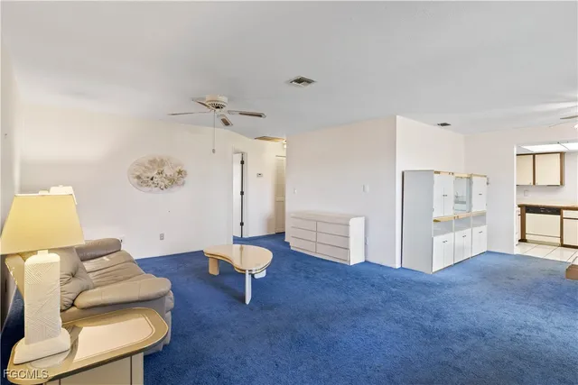a living room with furniture and white walls