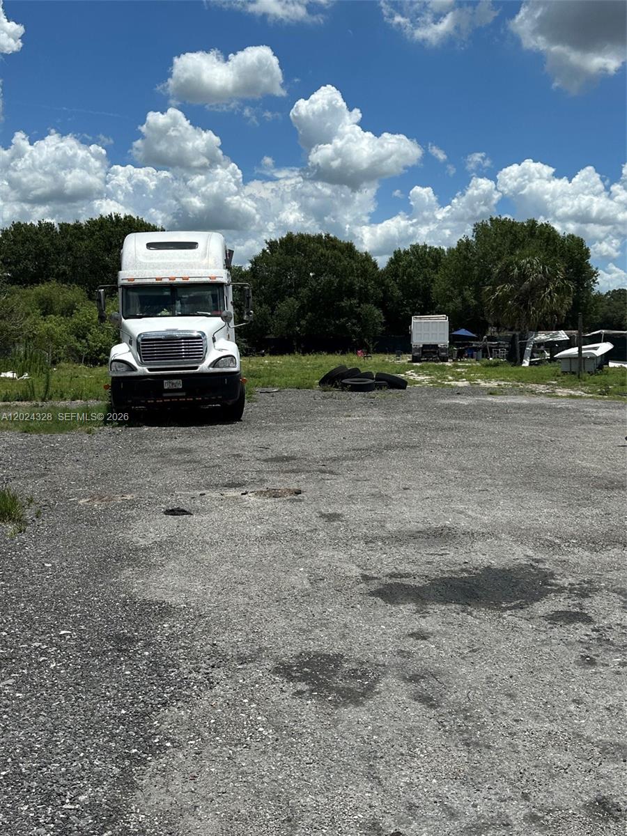 625 North Quebrada Street Clewiston, FL 33440 - Photo 26 of 26 a car parked in the middle of a field