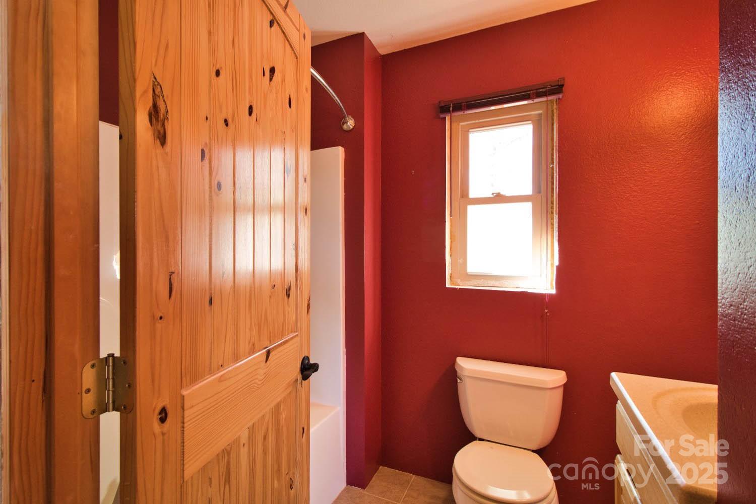 155 Northridge Drive, Unit 79 Rutherfordton, NC 28139 - Photo 16 of 31 a bathroom with a toilet a sink and a mirror
