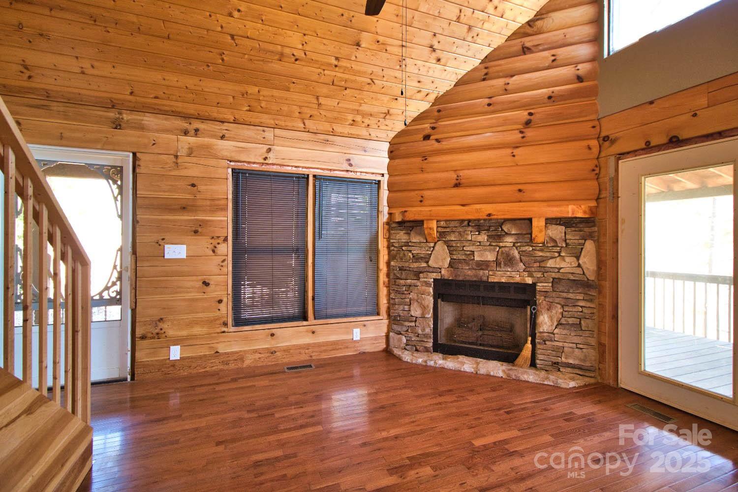155 Northridge Drive, Unit 79 Rutherfordton, NC 28139 - Photo 6 of 31 a view of an empty room with wooden floor fireplace and a window